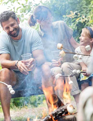 Cute girl sitting at a campsite, holding a pumkin